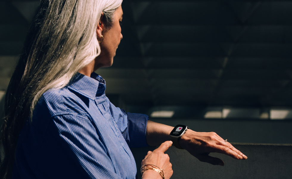A person reads a Hypertension alert on her Apple Watch Series 11
