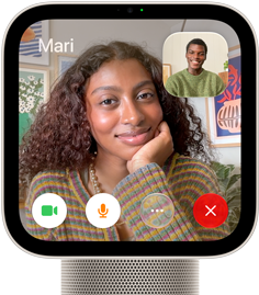 Apple HomeView, starlight (pale gold) color, front exterior, showing a FaceTime video call screen displaying one person in the main view and another person in an inset window, with control buttons at bottom of screen