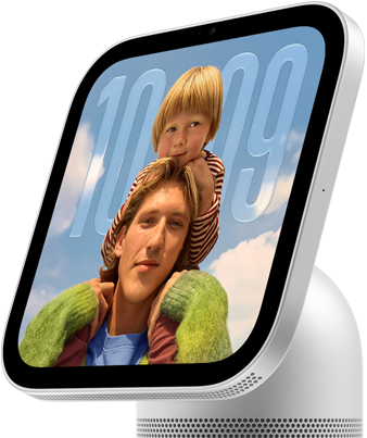 Apple HomeView, silver color, side exterior, semi-transparent time of day displayed on an image of a person carrying a child on shoulders, both looking forward