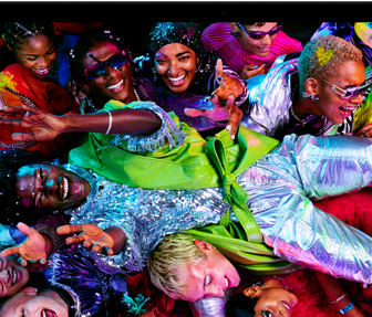 Colorful screen on a MacBook Pro of a person crowd-surfing at a party, showcasing the vibrant Liquid Retina XDR display