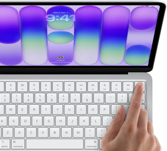 MacBook Neo, silver color, showing login screen, person's finger on Touch ID sensor in top-right corner of keyboard